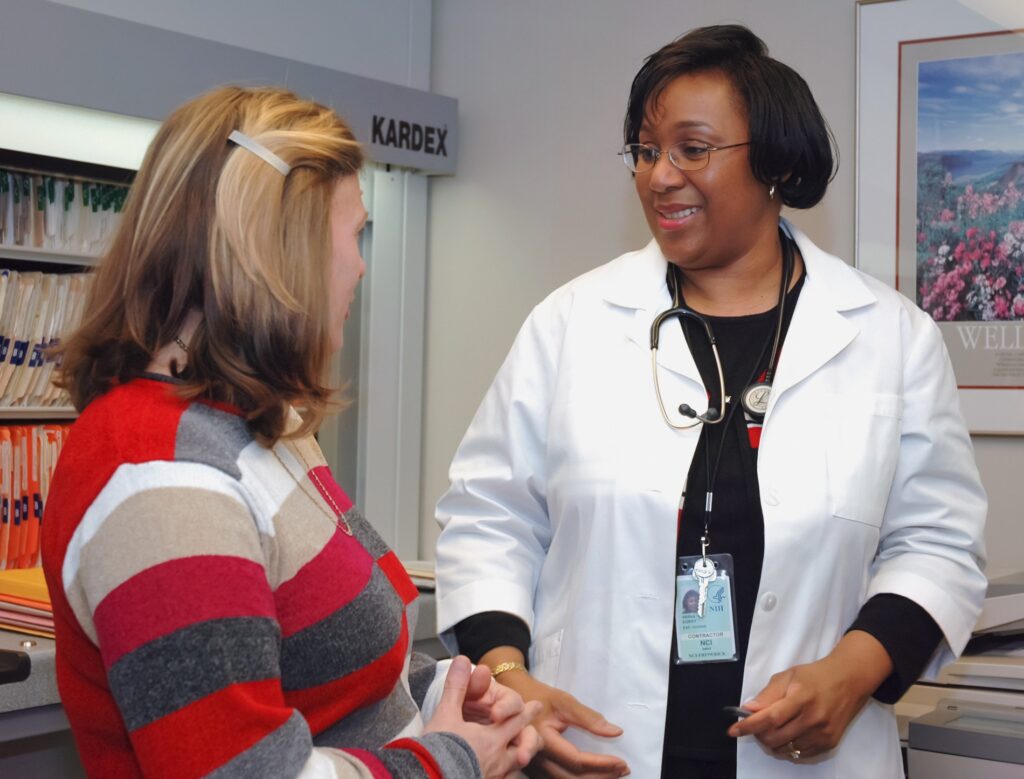 Woman doctor providing a medical consultation to her female patient in an office setting