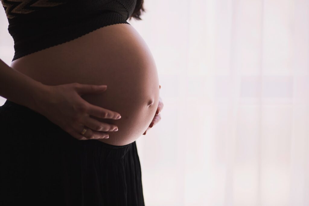 Pregnant woman holding her stomach