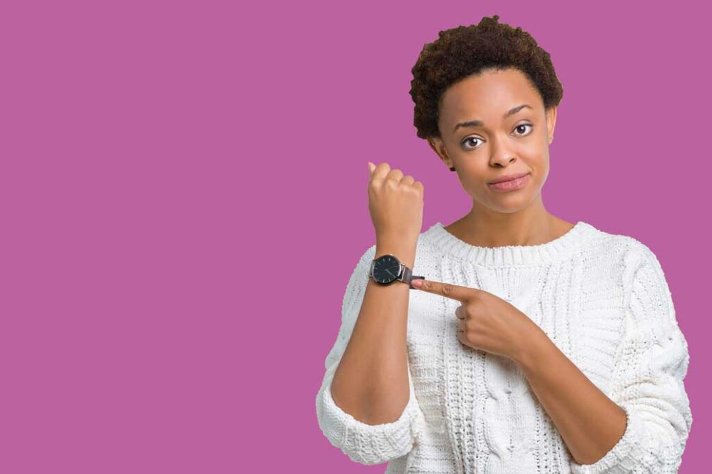 Woman pointing at the watch on her wrist