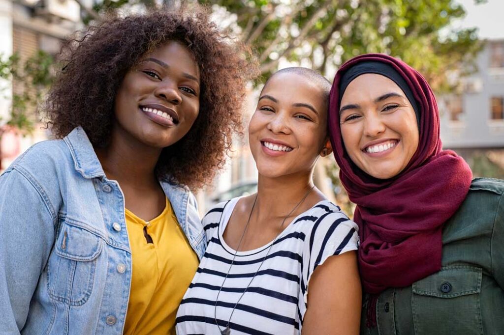 Three women smiling at the camera