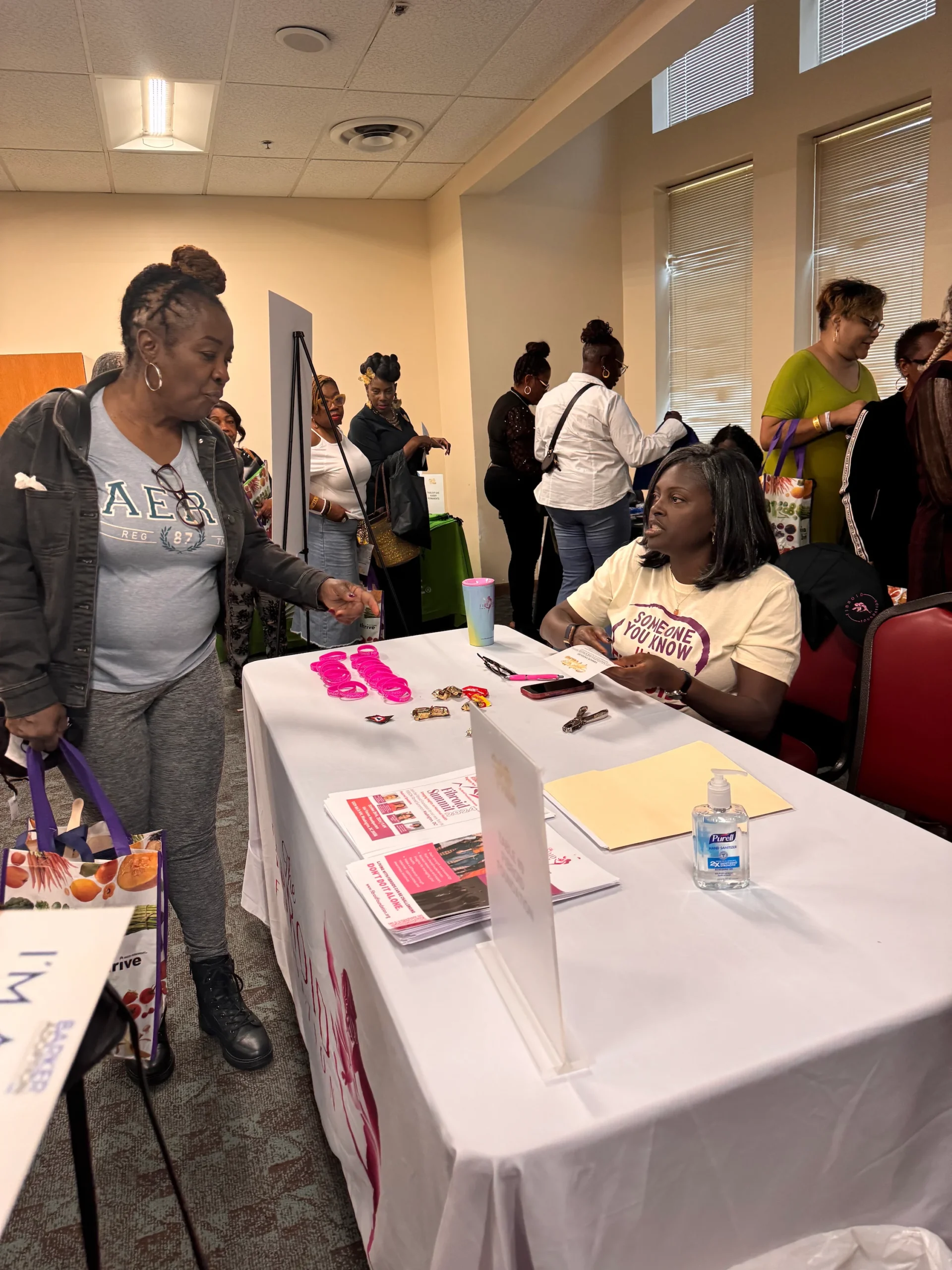 Fibroid founder Sateria connecting with an attendee at an information table